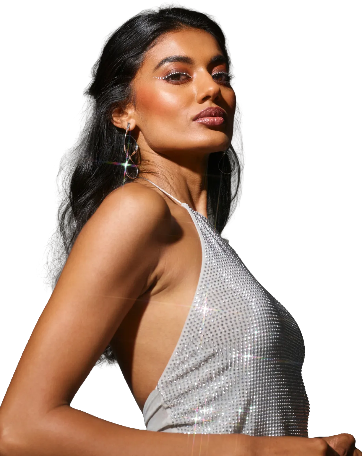 Ogle School student model in a silver sequin dress against a sparkling backdrop